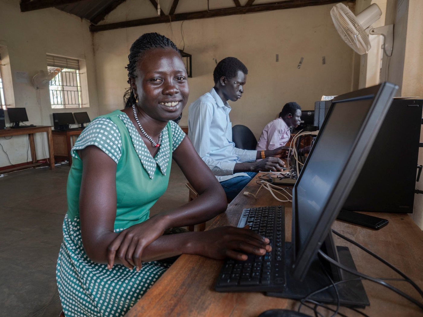 Adau (24) fled from South-Sudan in 2014 with her mother and sister. She was out of school for five years but have now completed the online training course. She is waiting for her enrolment at the Kampala University. Adau is dreaming of pursuing a carrier in social network.

Only 3% of refugee youth have access to tertiary education, compared to 36% of the world’s youth. While a growing number of programmes provide tertiary education opportunities to refugees through scholarships and distance education these are few and with little documentation about processes and outcomes. The partnership between. Arizona State University (ASU) and Norwegian Refugee Council (NRC) is a direct response to this need.

In August 2018, ASU and NRC signed a Memorandum of Understanding to establish an ASU Earned Admission programme at Ayilo and Nyumanzi refugee camps in Adjumani District, Uganda. The programme provides students with access to online courses through the university’s Global Freshman Academy.

25 South Sudanese and Ugandan learners participated in the programme. 40% are female and the makeup of the group otherwise reflects the importance of working hand-in-hand with the host community.

Location: Youth Center in Nyumanzi Settelment, Adjumani, Uganda 
Photo: Ingrid Prestetun/NRC