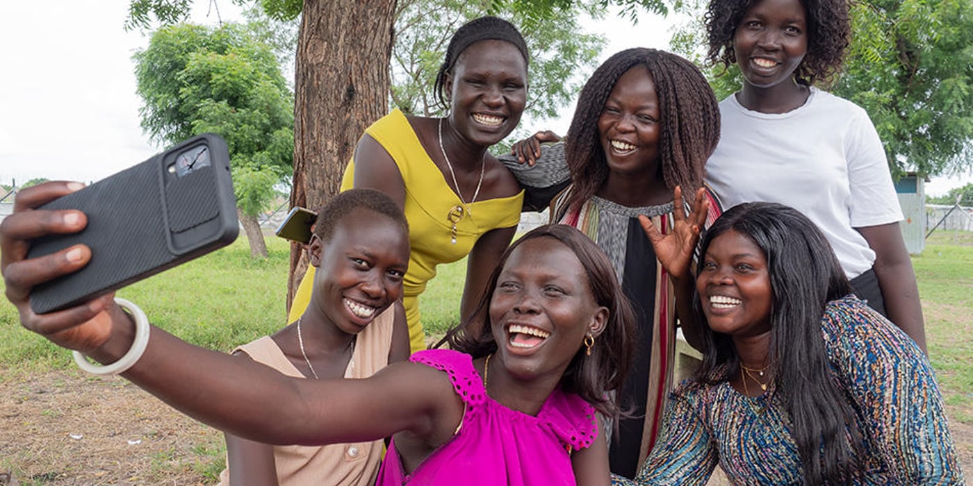 A group of young women smiling and posing for a selfie.