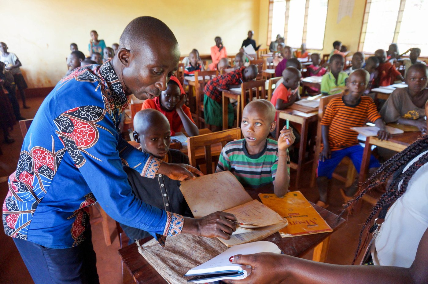 In green: Bikorimana Jean Dieu, 10
In black: Ndizeyimana Clauvis, 10
Teacher: Nimbona Dieudonné, 36
NRC offers classes to children who have missed out on school and are not able to attend classes with children their own age. After attending our programme, kids can take a placement exam (with IRC) to be placed in formal education. Our classes take place on the other side of camp from the youth centre (5km), so to encourage more children to come to school, we also hold one class in the youth centre.
Photo: Guri Romtveit/NRC