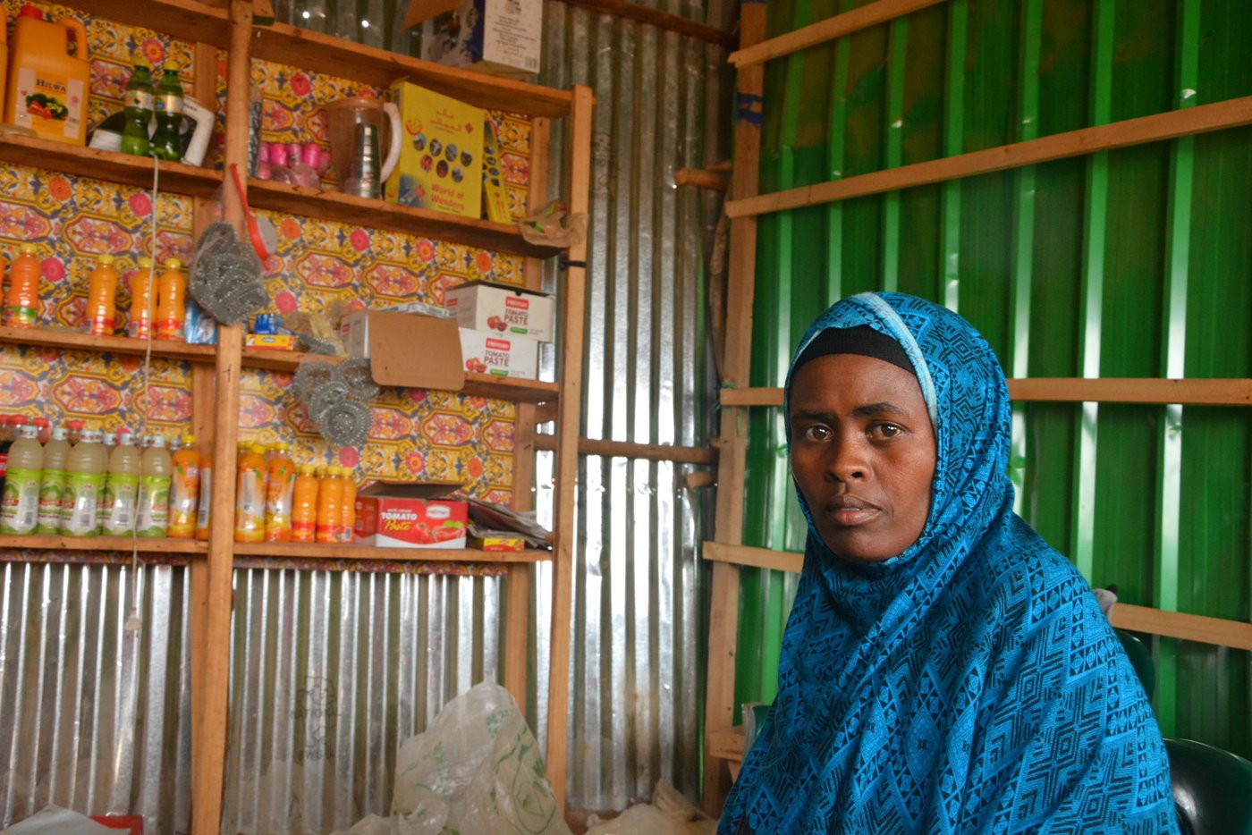 Fadumo Sharif, 29, is a mother and businessperson that live in Dolo-Somalia. She is the sole income source for a family of nine members. Fadumo has received ‘entrepreneurship and business management’ training and small grant of 500 USD to boost her business. She says, “Previously, our livelihood depended on collecting and selling woods. During the last drought, things very hard and we used to have two meals a day only. Luckily, I was enrolled in the business training conducted by NRC through the community elders. We were trained on business management and we received grants amounting to 500 USD to invest into our existing businesses. However, I decided to invest into new more profitable business than wood collection. I built a kiosk on my land and started with a small shop. Things have changed to better now. The business is going well. My children are able to go to school. Food shortage problem is solved and we are able to pay the water bills.”