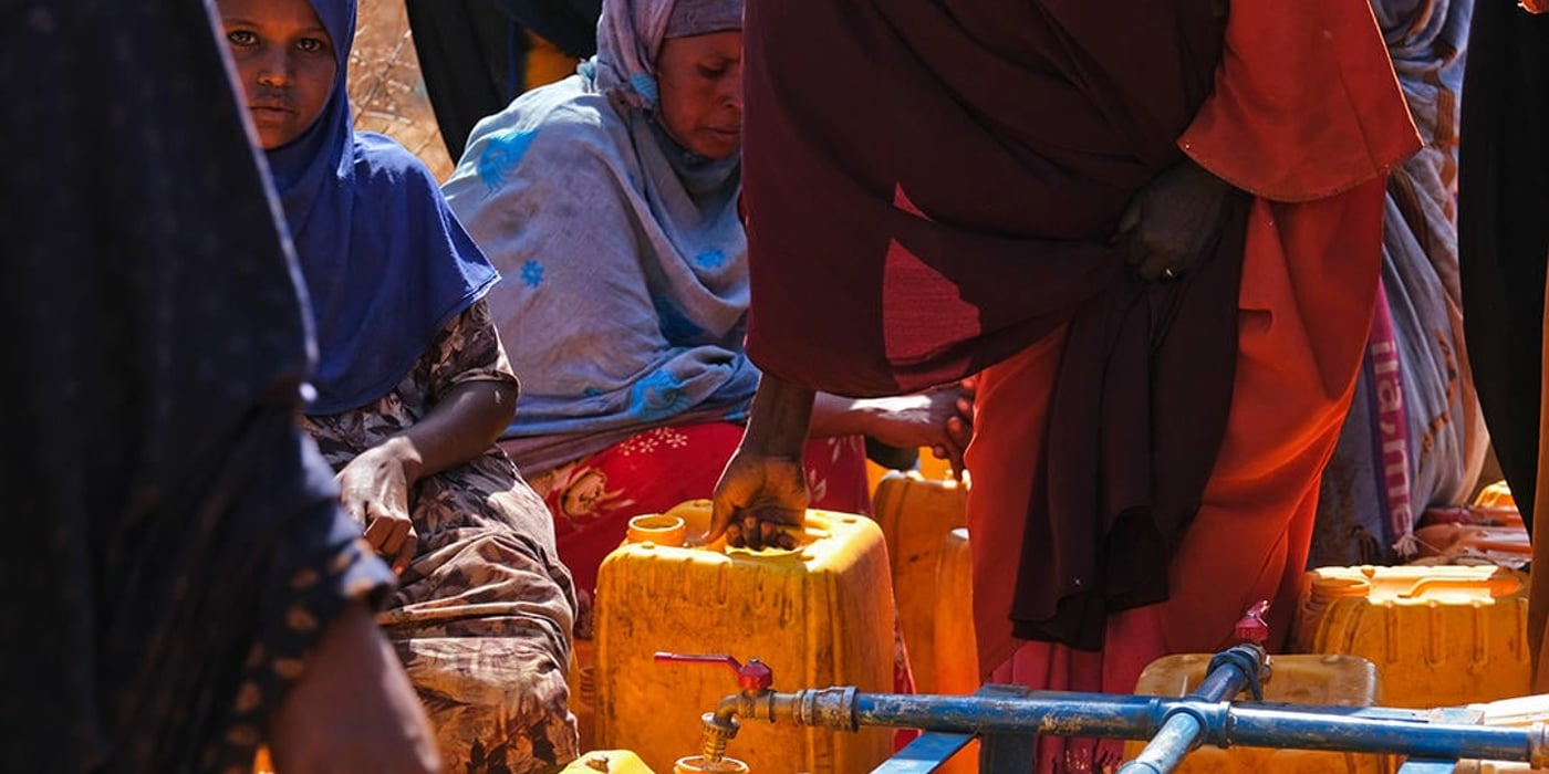 People filling water cans.