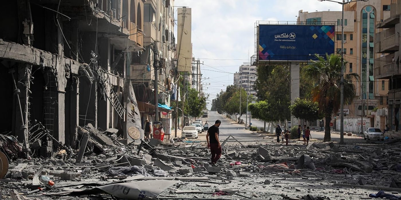 A Palestinian man inspects the ruins of Al Jawhara Tower at the centre of Gaza CIty after it was bombed the previous night.12/5/2021