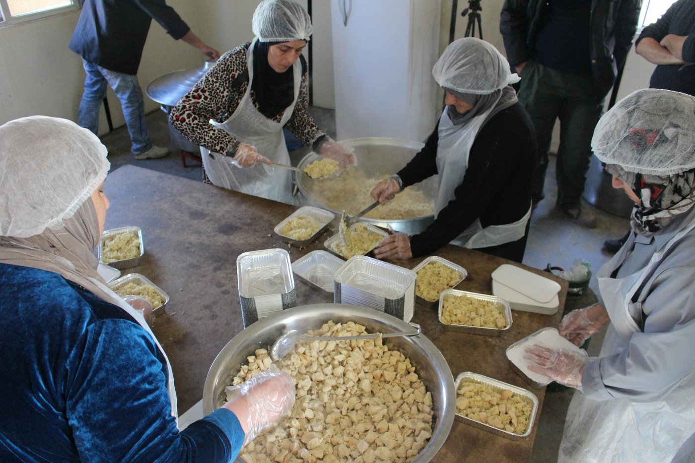 Khitam, a 54-year-old woman from Syria, lives in one of the biggest refugee settlements in Lebanon, together with more than 1,500 refugees. She is one of seven refugee women cooking meals that are distributed to the refugees living in the settlement. 

"I work to support myself. My situation is dire and I don’t have anyone else who can provide for me," says Khitam.

Thanks to the generosity of our private sponsors, the Norwegian Refugee Council (NRC) was able to provide funding to a local Lebanese organisation, Union of Relief and Development Associations (URDA), that set up a kitchen in a refugee settlement in the Bekaa Valley in eastern Lebanon. URDA employs refugees to cook the food and distribute the meals to thousands of refugees living in tented settlements. 

Fled from Syria six years ago

Six years ago, Khitam fled from Homs in Syria to Lebanon with her husband and children. Her husband died three years later, leaving her alone. 

"My children have families and are barely able to feed their own children. I could never ask them to provide for me as well," she says. 

She is happy to be a part of the cooking group in the camp.

"Cooking food for other refugees makes me happy and the salary makes me able to support myself. It’s heavy work – we do everything from cutting chicken and boiling rice, to cleaning and preparing food boxes for over 1,000 people."

Over 1,500 meals for 300 refugee families

In March 2019, NRC supported the preparation of over 1,500 meals for 300 refugee families, the majority of whom were evacuated from their homes after the winter storms. Some of them have still not been able to return to their homes as their tents are being rehabilitated. 

Khitam and the other women receive a lot of positive feedback from people saying they’re enjoying their food. 

Through the cooking, the women come together and are able to keep their mind off their current lives as refugees. 

"Knowing I contribute to put food on the table for other refugee families and to feed their children makes it worth all the hard efforts I put into my cooking,” says Khitam.

Credit: Racha El Daoi/NRC