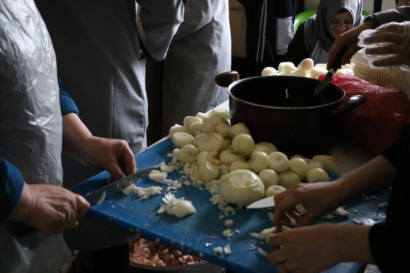Through a rotating schedule with many other women from the settlement, several of refugee women including Khitam were selected to be part of the final group that prepares and cook meals when needed. “Cooking food for other refugees makes me happy and the salary is vital for me to support myself. The workload is heavy as we do everything from cutting chicken, to boiling rice, to cleaning and preparing food boxes to over 1,000 people,” says Khitam.
Photo: Nadine Malli/NRC