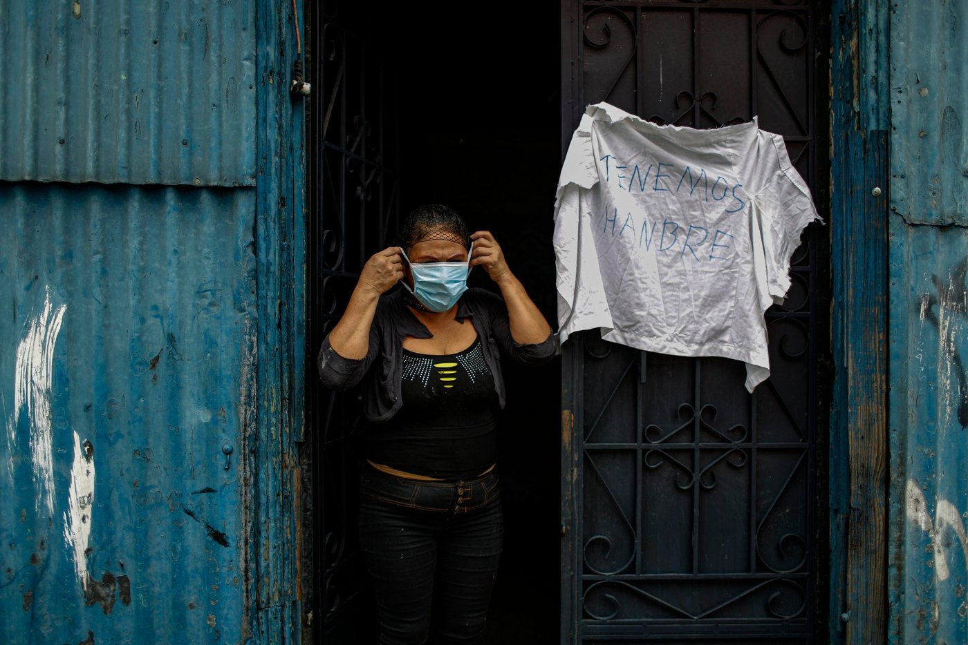 A woman stands outside a rooming house waiting for help after putting up a white flag indicating that they no longer have any food left during a nationwide quarantine as El Salvador's government undertakes steadily stricter measures to prevent the spread of the coronavirus disease (COVID-19), in San Salvador, El Salvador May 14, 2020. Picture taken May 14, 2020.
© European Commission /DG ECHO/José Cabeza