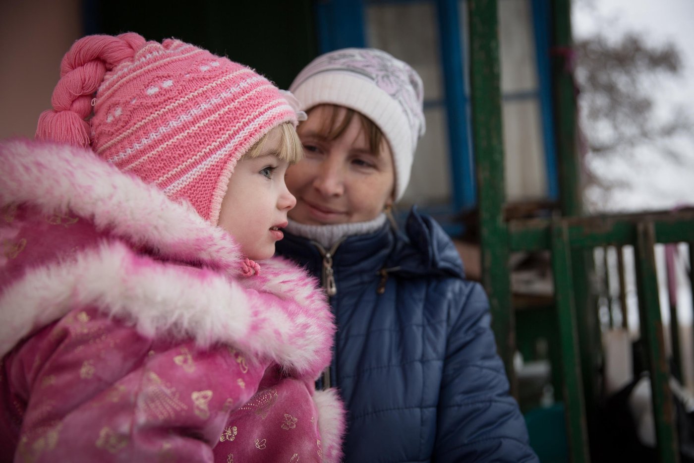 Veronika (4) 

Kateryna Matuliz is 29 years old, mother of 3 children, from Popasna town.

“I lived with my husband and two daughters in our own apartment in Popasna. But, four years ago the war came to our town and the constant shelling makes it too risky to stay at home anymore.  When the conflict started I was pregnant with my third daughter. One of the shells hit the house of our neighbor and I got so stressed that we immediately had to go to the maternity ward in a town nearby and our daughter Veronika came to this world a little bit earlier”, Kateryna says. 

Kateryna and her three daughters moved to her mother’s house in a safer part of the town. The house is very small without basic facilities and can hardly accommodate the big family. Kateryna’s husband left to Russia several years ago to help his sick mother and cannot afford to come to see them often. 

“It is impossible to come back home now since the shelling has become even more frequent lately. Every day I have to travel to that district with my children because of school and kindergarten. My daughters also attend dancing and gymnastics there, and we do not want to change our teachers. Every evening we come back to my mother’s home to do homework and to stay overnight. I cannot work, because my youngest daughter gets sick very often”, says Kateryna. 

Kateryna’s mother’s house is very old and is located in an open area near the lake where it usually is very windy. To support the family in the winter period, NRC provided them with insulation materials and helped to repair the damaged roof. Kateryna says it has become much warmer than before, and they spend less fuel to heat the house. 

Photo: Ingebjørg Kårstad/NRC