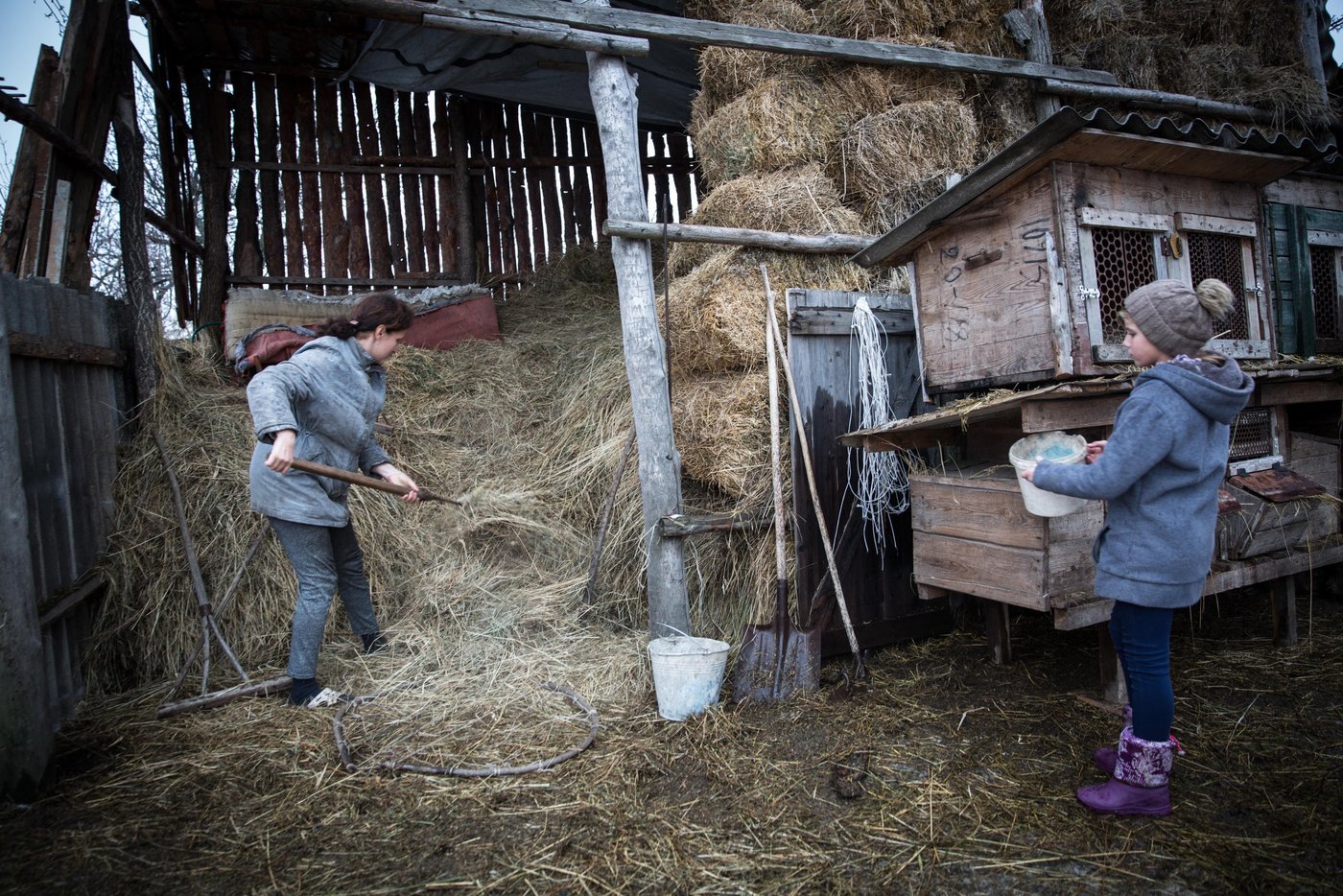 Iryna is 10 years old, and Liliia’s eldest daughter. She still remembers the night their house was hit. Iryna and her sibling all suffer from post-traumatic stress. It is hard to concentrate at school and she has nightmares and anxiety. “The main concern for me now is that the active phase of the war does not break out again. I am afraid that my house will be destroyed again. After all, we hear the sounds of shots every night,”says her mother Liliia.
Background story:
Liliia Poturoieva is 39. She has experienced terrible events that completely changed the life of herself and her large family and left an indelible mark on everyone's soul. She lives in the frontline village of Verkhnia Vilkhova in Stanytsia Luhanska district, Luhansk region.
Liliia has six children. The oldest is Oleksandr. He is 20. He lives separately from his parents and earns his own living. Ihor is 12. He is a shy and calm schoolboy, always ready to help parents with the housework. Her eldest daughter Iryna is 10. She is a schoolgirl and mother's main housekeeper. She cooks and looks after younger children. Yana is 7. She is a first-grade pupil. She is a cheerful, active and very energetic girl. The children are forced to go to school in a neighboring village 5 kilometers away, since there is simply no school in their village.
Her youngest son Illia,5, and daughter Aryna, 2, are always staying at home with their mother. The family cannot afford a kindergarten for children. Now Liliia is pregnant again. This will be the seventh child in the family. Her husband Viktor helps her to cope with all of them.
Before the conflict, the whole big family lived in a small house with two rooms. There was no work. The main income was child allowances and random earnings from the cows, goats, rabbits and poultry.
“There was no work in the village. There was no opportunity to travel to other settlements to work. We tried to make money by selling milk”.
In February 2015, at midnight, heavy shelling began. Viktor, Liliia's husband, went out into the yard to see the direction of the shots. Suddenly a shell fell near their yard, and the second shell landed 7 meters away from Viktor, who was standing on the house porch. Viktor got a serious shell shock and lost his hearing for a while.
The blast wave knocked out all the windows in the house. Under one of the windows there was a child's bed, where Liliia’s youngest son slept. That night Liliia saved the life of her son with her son.
“When the blast hit, I covered my baby with my own body, and the glass from the broken window hit me in the back”.
The consequences of that shelling are still noticeable. Liliia has problems with her speech. She is stuttering. She is not the only one.
“The children experience anxiety, concentration problems, fears and, as a result, urinary incontinence”.
The house was seriously damaged in the blast. All the windows were broken, the front walls were destroyed and the roof and the foundation were seriously damaged. However, Liliia and her family did not dare to leave because it was too risky to leave the house unattended. They tried to repair the house on their own. They covered the broken windows with plastic wrap. They even had to spend their nights in the basement because it was the warmest and the safest place in their household.There was no help from the local authorities.
“At first I didn’t want to ask for help. I did not believe that anyone would really help us. My husband advised me to go to the NRC office and find out about the Heavy repair project, because he heard that NRC had already helped someone in the village”.
Now the house is in the process of restoration. There is a new slate on the roof. Renovation works on the walls have been completed. Three small rooms for the children have been completed. New windows have been installed and internal works are being carried out now.
“The main thing for me now is that the active phase of the war does not break out again. I am afraid that my house will be destroyed again. After all, we hear the sounds of shots every night”, Liliia says.
Photo: Ingebjørg Kårstad/Norwegian Refugee Council
