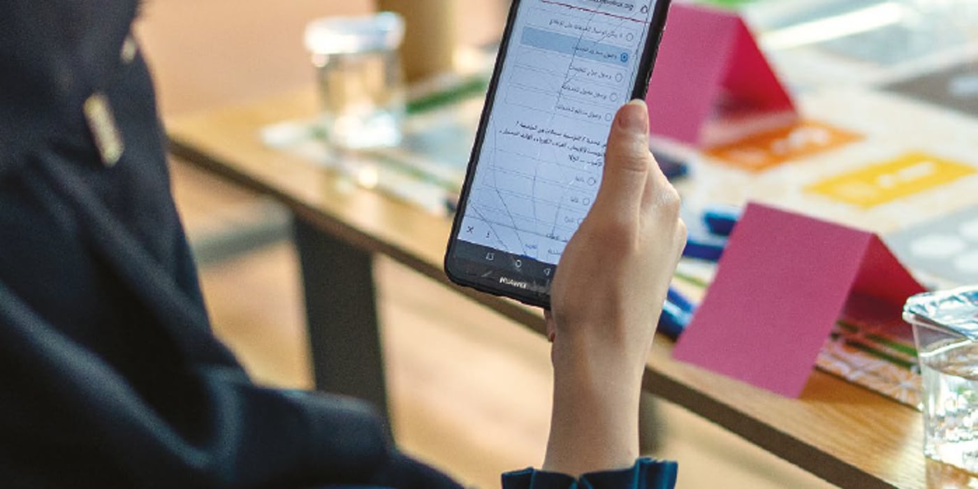 A hand holding a phone.