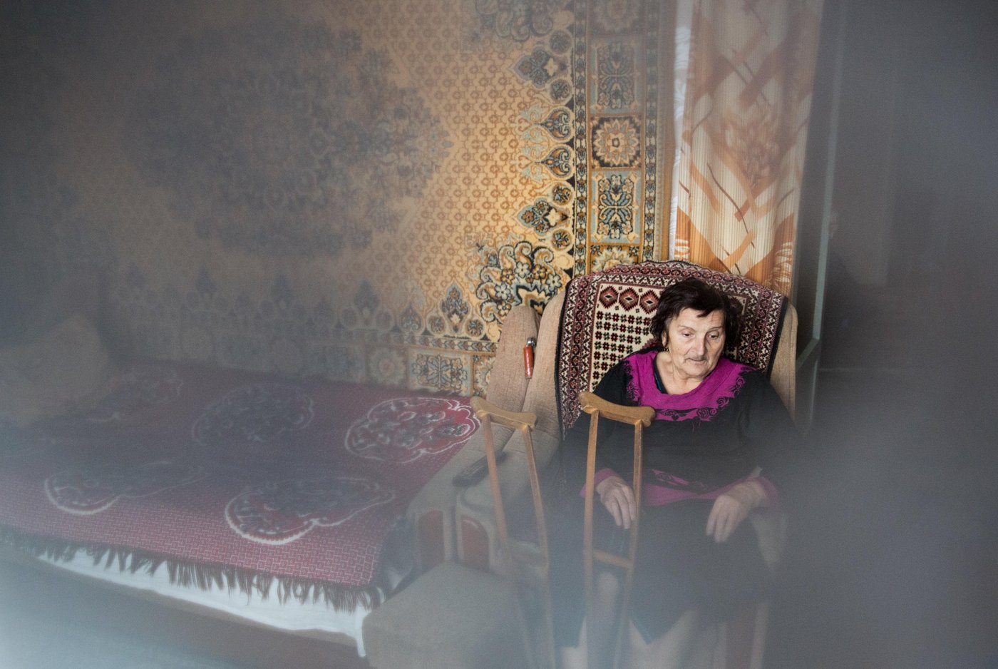 Olha Nazarova, 68, is a pensioner from the small frontline town of Shchastia in Novoaidar district. Olha has been living in this town since she was 18. She lives alone. The old woman is suffering from limited mobility, and she needs crutches to walk.
“Four days ago, I fell and hit my head so hard. The first day I was at home laying down, because it was very bad. Then a friend came in and cooked me a meal”.
Still, Olha feels dizzy and frail.
During the active phase of the armed conflict, Olha did not leave the city. She experienced all the horrors of war in her own flat on the outskirts of the town. The blast shattered all the windows in the flat.
In 2018, representatives of the Norwegian Refugee Council told Olha about the Food for peace programme, and Olha received the necessary financial assistance to buy much needed products.
Photo: Ingebjørg Kårstad/NRC