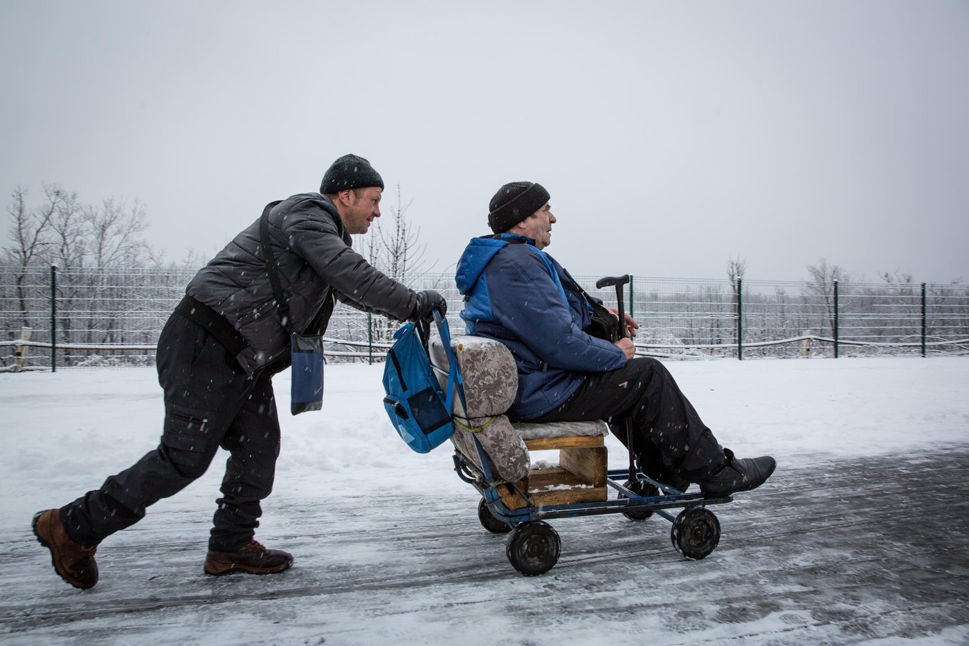 Every day thousands of people, many of them elderly, have to cross the checkpoint between government controlled and non-government-controlled areas of Ukraine at Stanytsia Luhanska. The bridge is destroyed, making it impossible for cars to pass, forcing people to walk for several kilometres through no man’s land and wait for 3-4 hours to pass each way.
For those who are unable to make the walk, Slavik is ready to offer transport for a small fee. He works at EECP every day.
“I use this wheelchair to transfer elderly people. They have the same problems: a small pension, and expensive medicines. There are many people. The elderly people constantly complain about life. They have to show up in person every month in order to receive their pension", says Slavik.
Photo: Ingebjørg Kårstad/Norwegian Refugee Council.