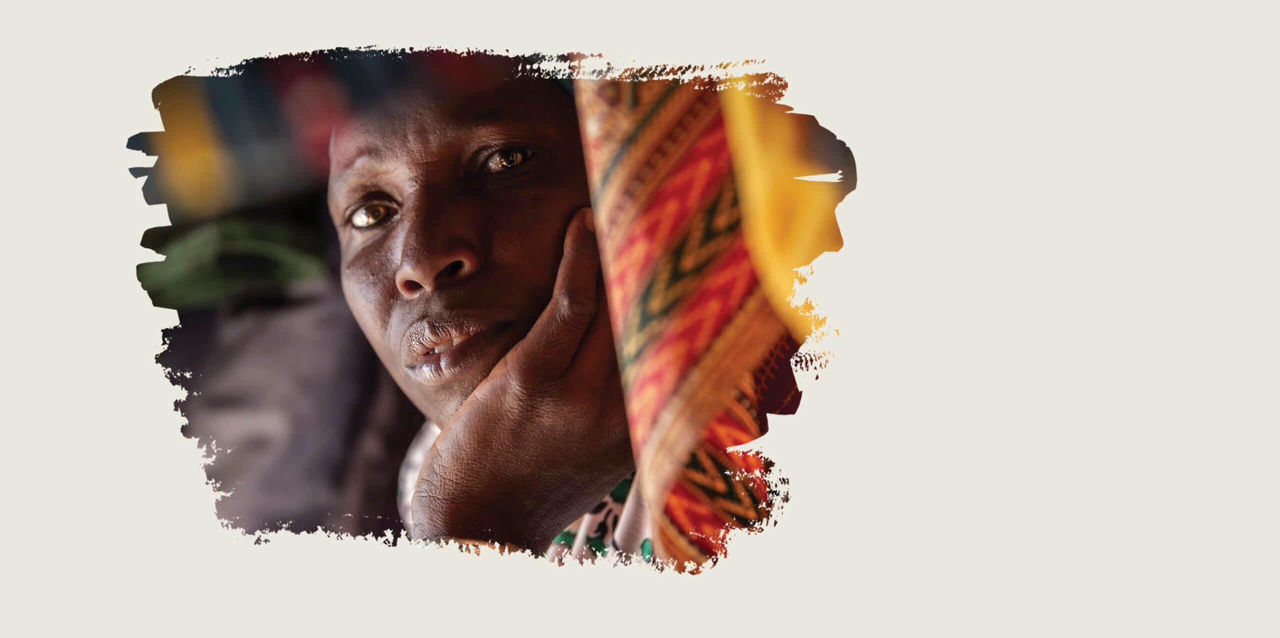 Sand coloured graphic with an image of a woman resting her head in her hand, surrounded by colourful fabric.