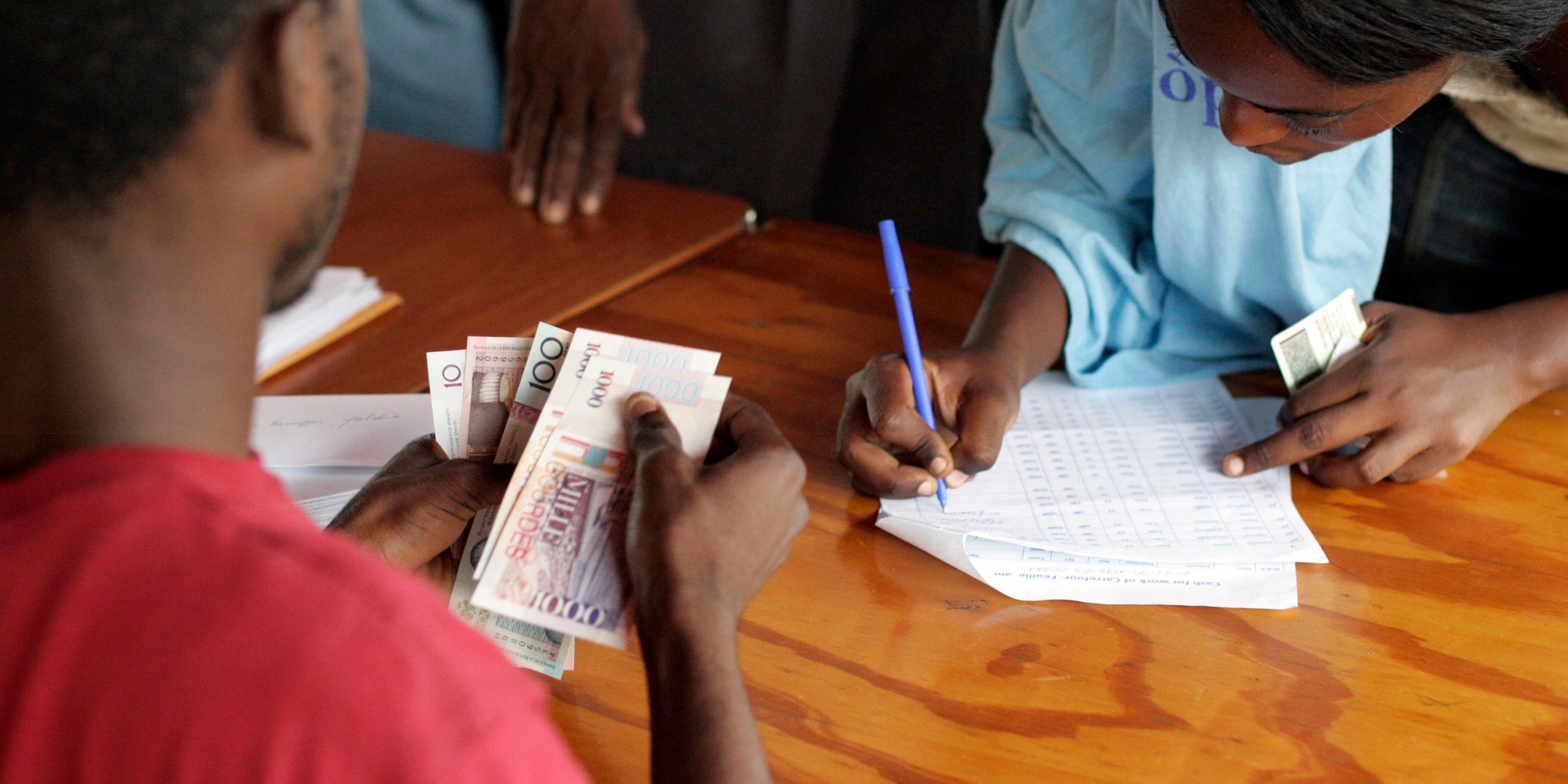 Haitians at the Sant Triyaj Fatra Kafoufey recycling factory in Port-au-Prince queue to receive payment for their street-cleaning work through the "Cash for Work" programme, an initiative launched by the United Nations Development Programme (UNDP) in the aftermath of Haiti's earthquake. (Photo: UN Photo/Sophia Paris)