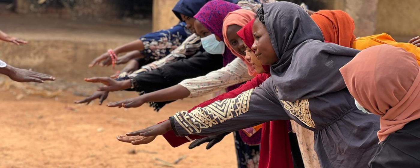 Students doing relaxation techniques, as part of a psychosocial support activity.